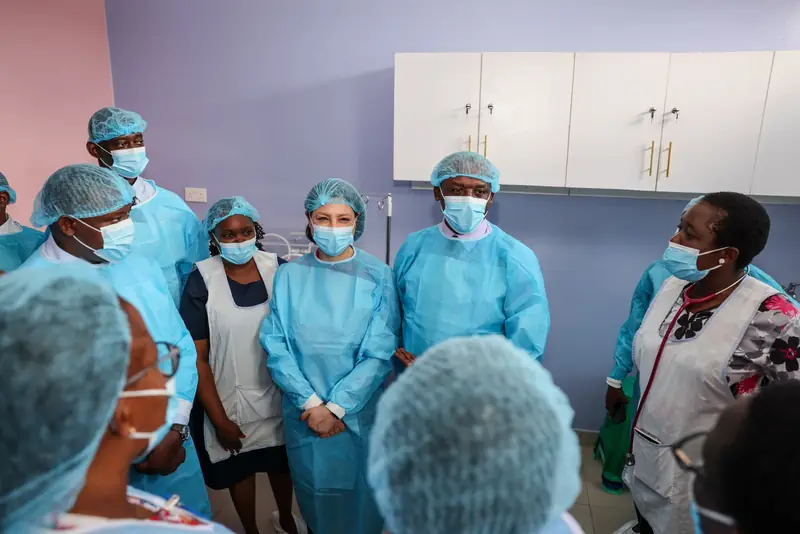 Governor Mutula and visitors in protective clothing inside the new neonatal care facility.